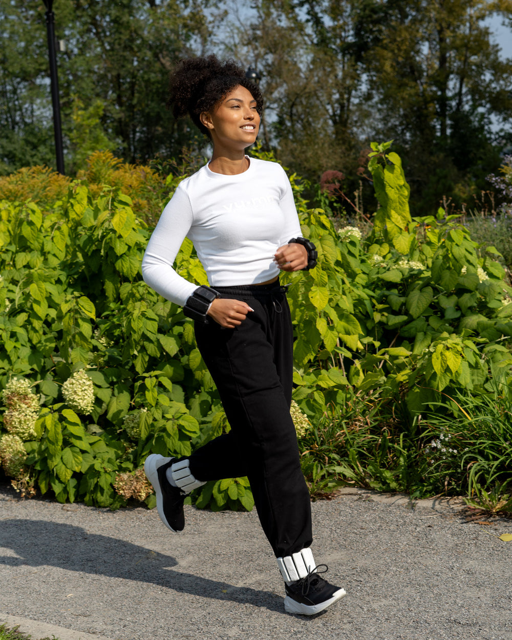 Woman wearing YU-MN Weighted Bangles during yoga workout